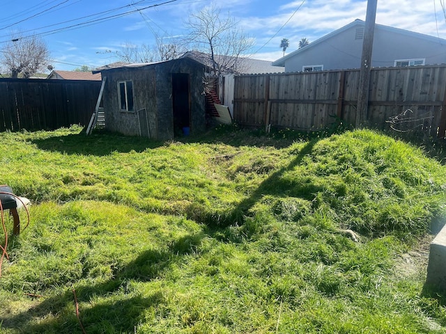 view of yard with an outbuilding and a fenced backyard