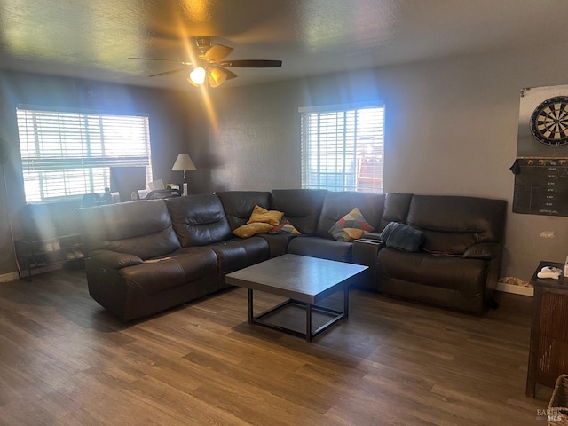 living area featuring ceiling fan, a textured ceiling, plenty of natural light, and wood finished floors