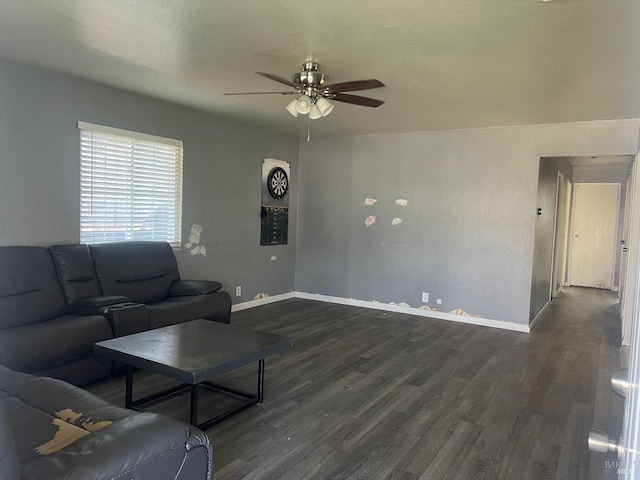 living area with ceiling fan, dark wood-type flooring, and baseboards