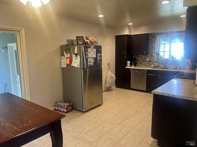 kitchen featuring tasteful backsplash, appliances with stainless steel finishes, a sink, and recessed lighting