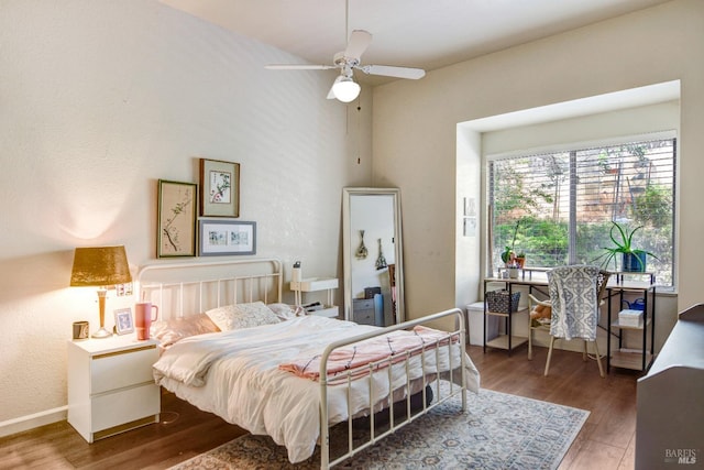 bedroom featuring dark wood-style flooring and baseboards