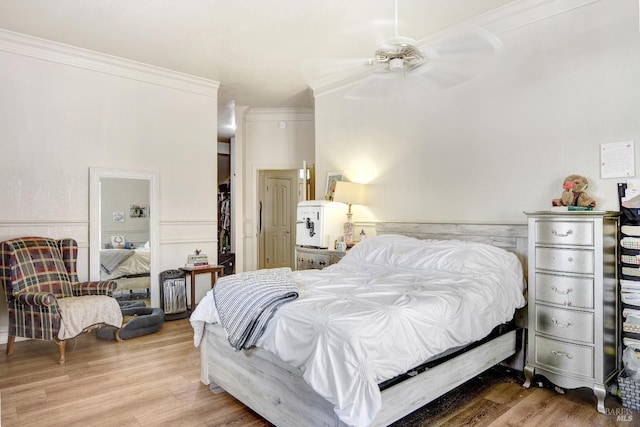 bedroom featuring ornamental molding, ceiling fan, and wood finished floors