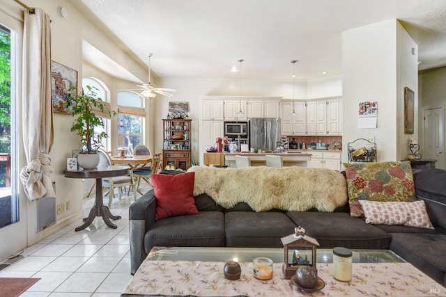 living room with light tile patterned floors, ceiling fan, and a wealth of natural light