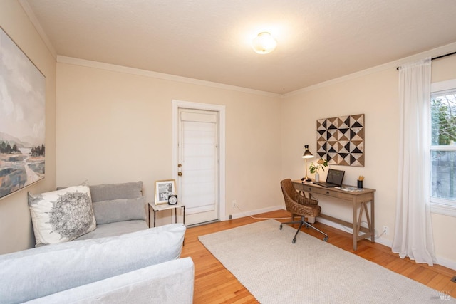 office with ornamental molding, light wood finished floors, and baseboards