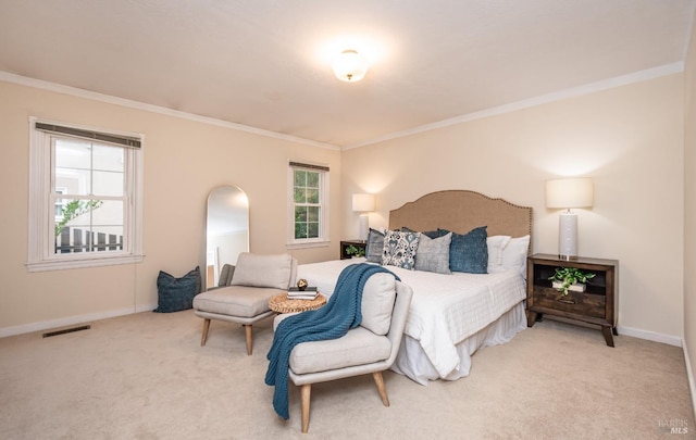 carpeted bedroom featuring visible vents, crown molding, and baseboards