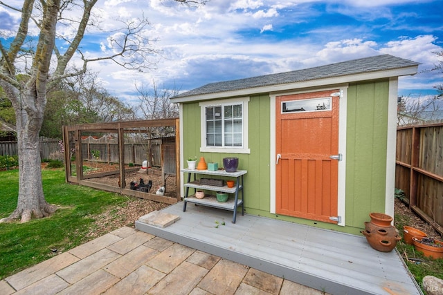 view of outdoor structure featuring an outbuilding and a fenced backyard