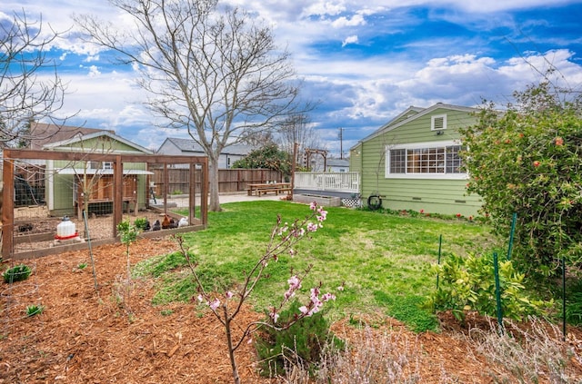 view of yard with an outdoor structure, exterior structure, and fence