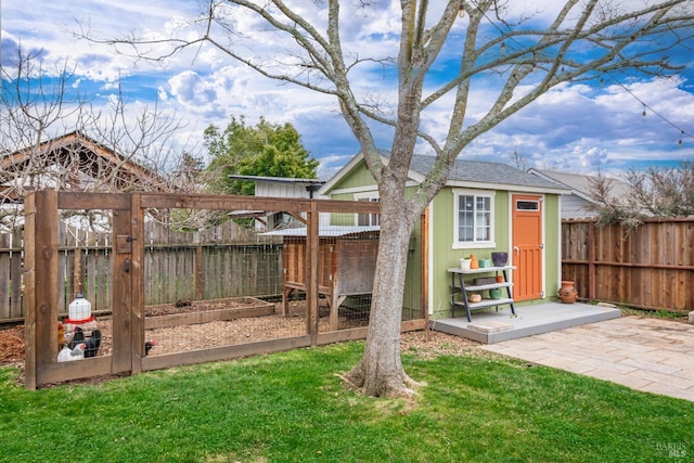 exterior space featuring an outdoor structure and a fenced backyard