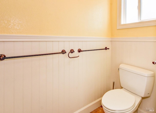 bathroom with toilet and wainscoting