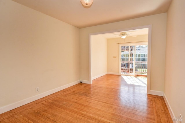 empty room featuring baseboards and light wood-style floors