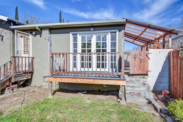 exterior space with french doors and fence