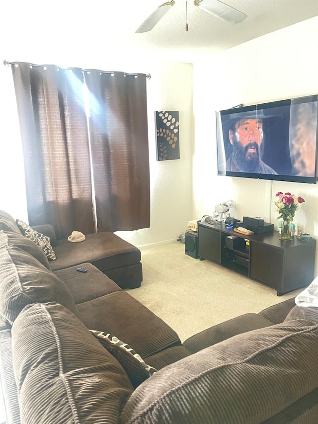 living room featuring a ceiling fan and light colored carpet