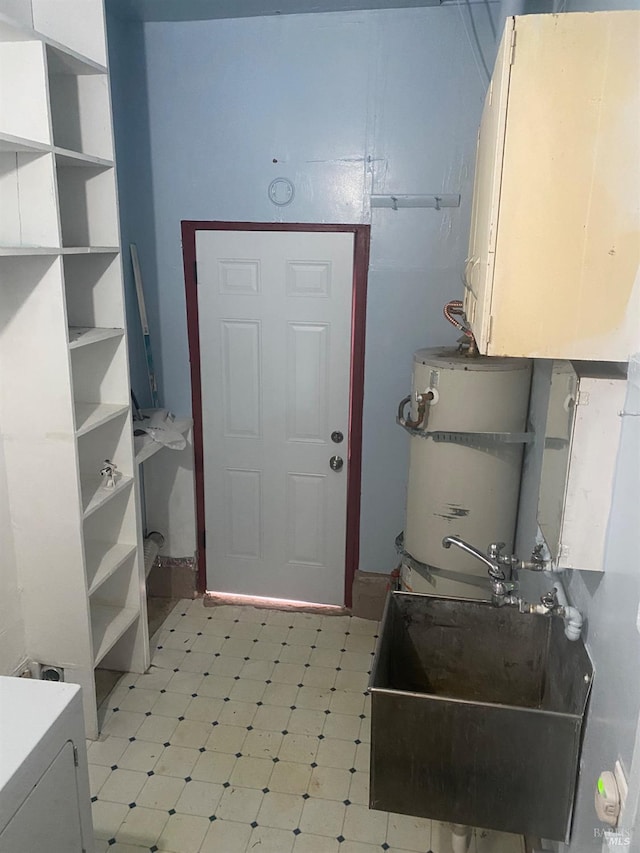 interior space featuring a sink, open shelves, light floors, and secured water heater