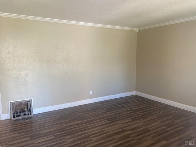 empty room with crown molding, dark wood-style flooring, heating unit, and baseboards