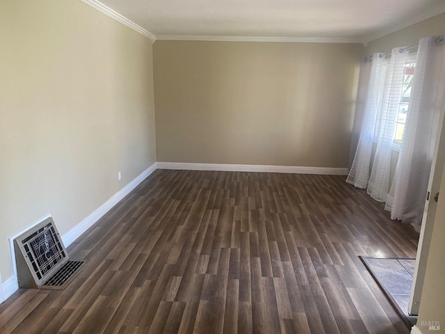 empty room featuring dark wood-type flooring, visible vents, ornamental molding, and baseboards