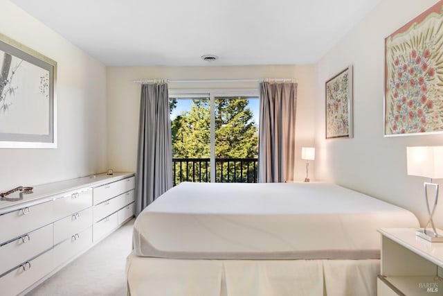 bedroom with light carpet, access to exterior, and visible vents