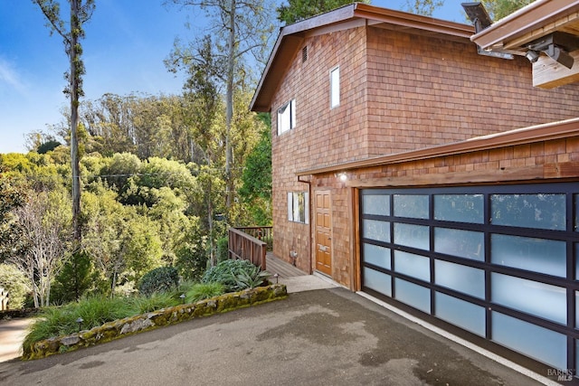 view of side of property featuring a garage and driveway