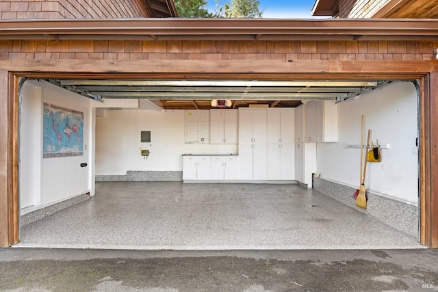 garage featuring a garage door opener and electric panel