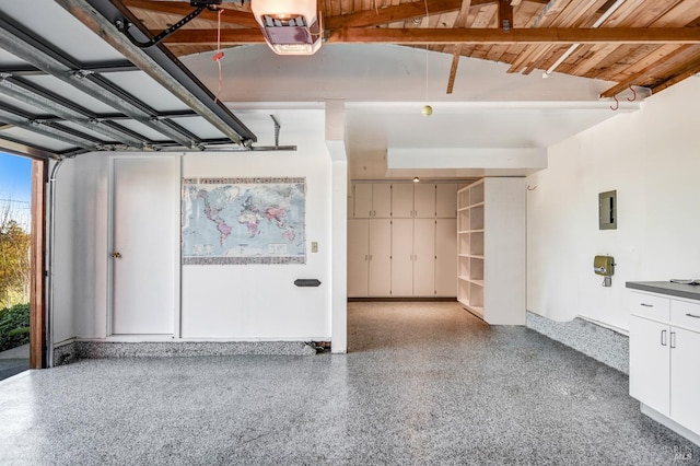 garage with wooden ceiling and a garage door opener