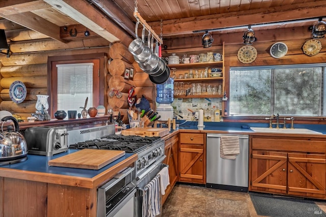 kitchen featuring wooden ceiling, a sink, appliances with stainless steel finishes, brown cabinetry, and beamed ceiling