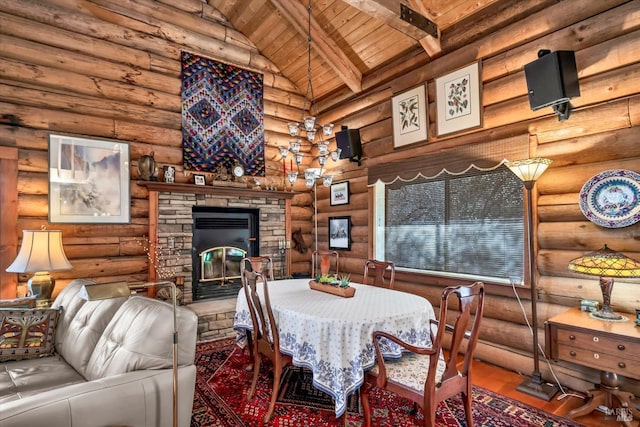 dining space featuring high vaulted ceiling, a stone fireplace, wooden ceiling, wood finished floors, and beam ceiling