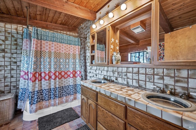 full bathroom featuring double vanity, wood ceiling, a sink, and beamed ceiling