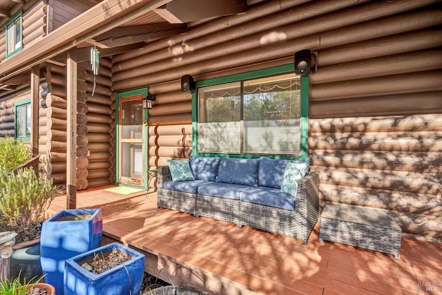 deck featuring an outdoor living space with a fire pit