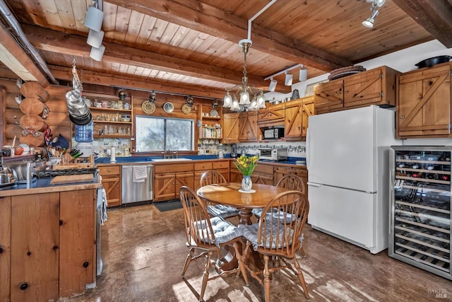 kitchen featuring beverage cooler, freestanding refrigerator, stainless steel dishwasher, black microwave, and a sink