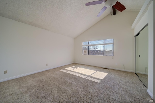 unfurnished bedroom featuring high vaulted ceiling, light carpet, a textured ceiling, and baseboards