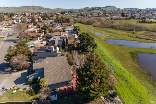 drone / aerial view featuring a residential view and a water and mountain view