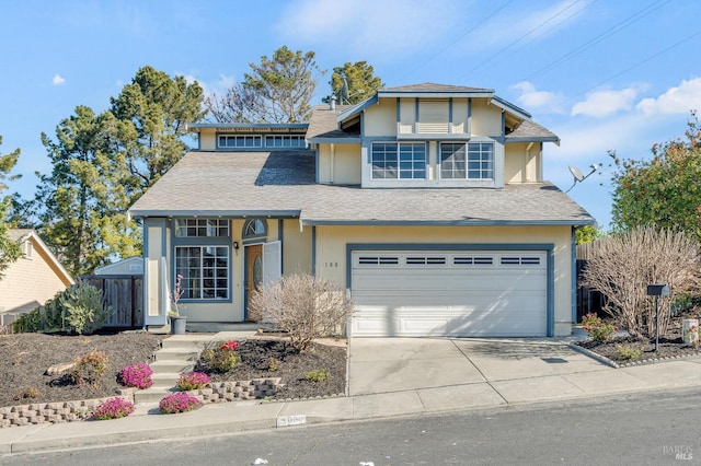 view of front of home with a garage, driveway, and roof with shingles