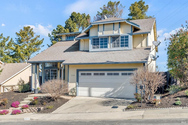 view of front facade featuring a garage, roof with shingles, and driveway