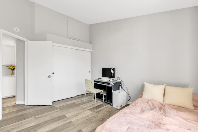 bedroom with a closet and light wood finished floors