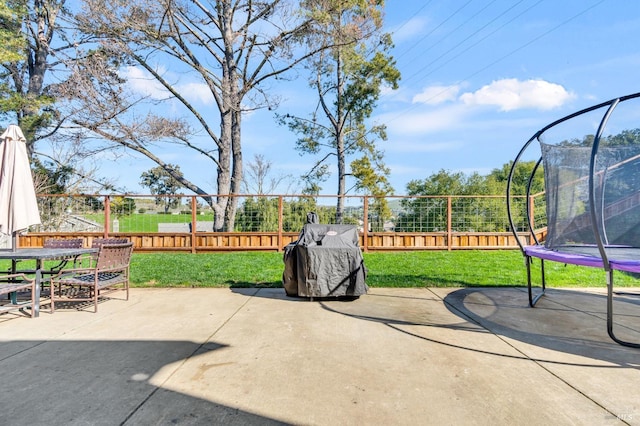 view of patio / terrace with a trampoline and a fenced backyard