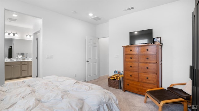 bedroom with light carpet, ensuite bath, visible vents, and recessed lighting