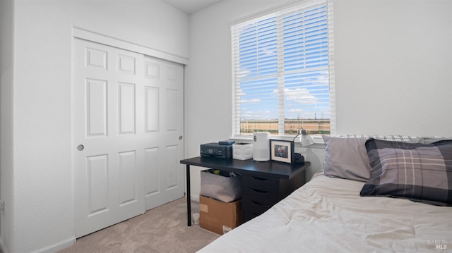 carpeted bedroom with a closet