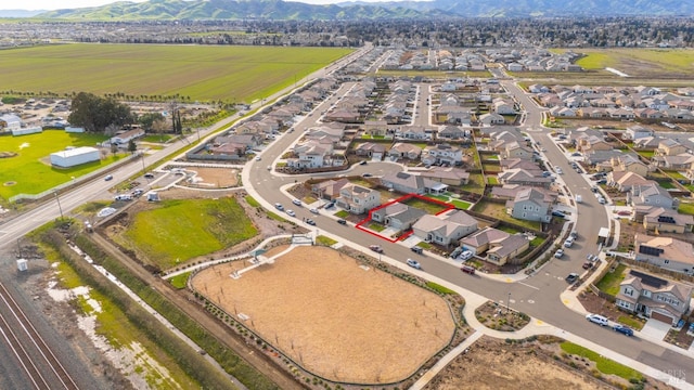 drone / aerial view with a residential view and a mountain view