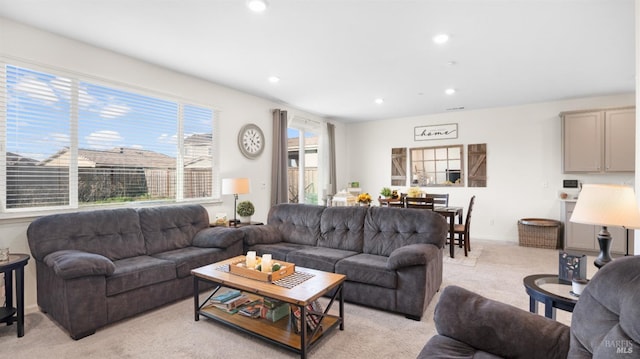 living area featuring light carpet and recessed lighting