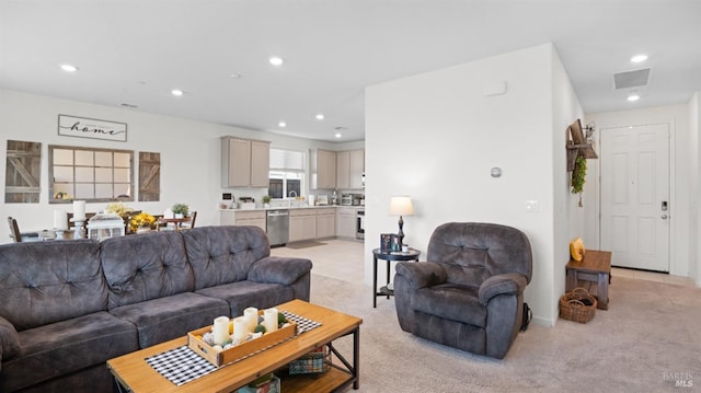 living room featuring recessed lighting, visible vents, and light colored carpet