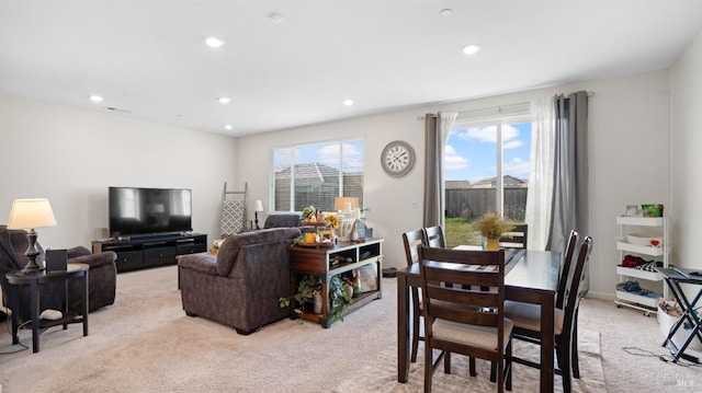 dining space with light carpet, a wealth of natural light, and recessed lighting