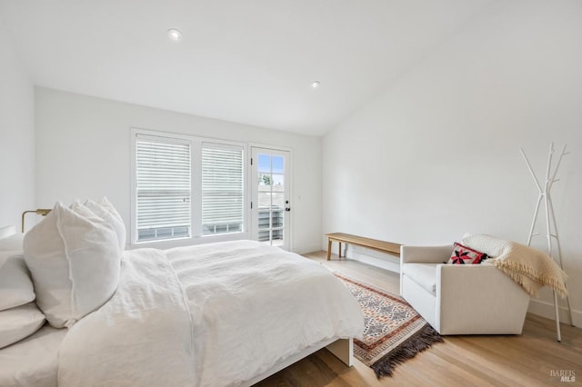 bedroom with recessed lighting, vaulted ceiling, baseboards, and wood finished floors