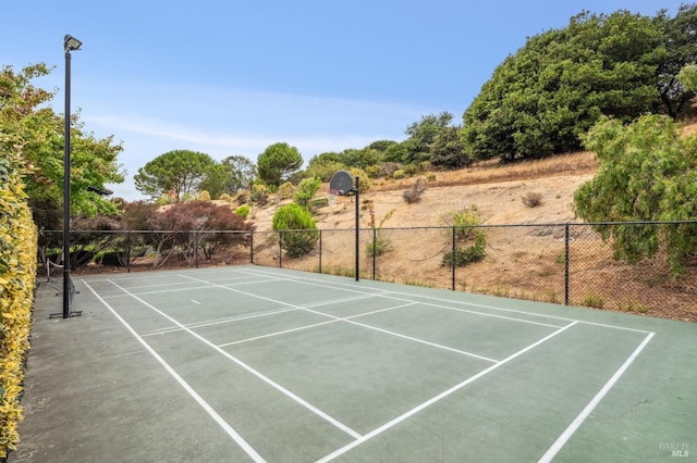 view of sport court featuring community basketball court and fence