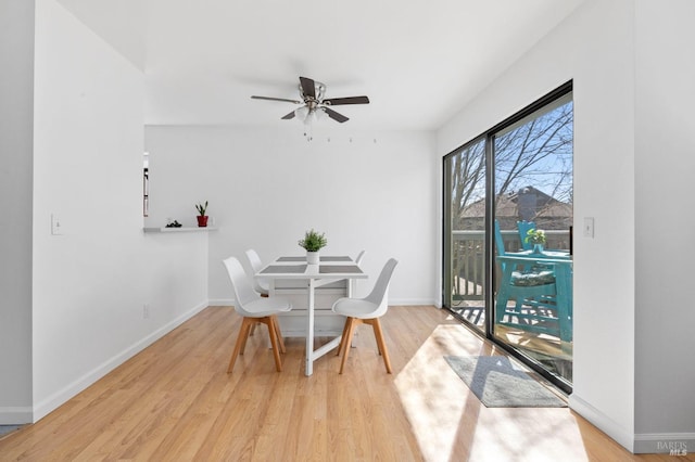 dining room with ceiling fan, light wood-type flooring, and baseboards