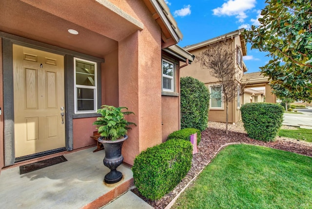 entrance to property with stucco siding