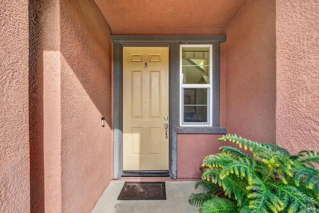 doorway to property with stucco siding