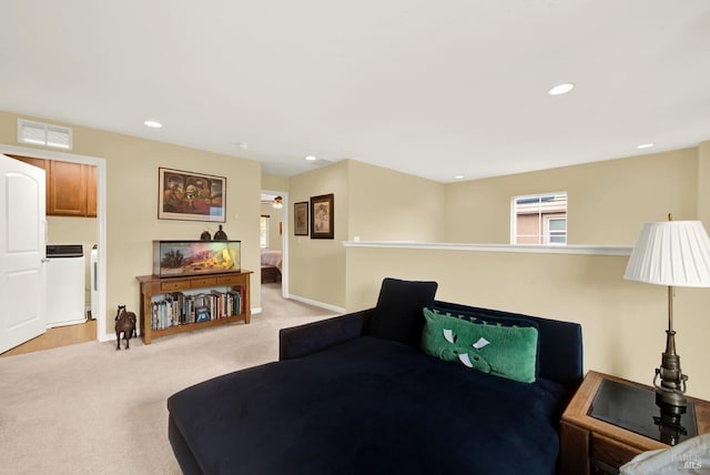 living area featuring recessed lighting, visible vents, baseboards, and light colored carpet