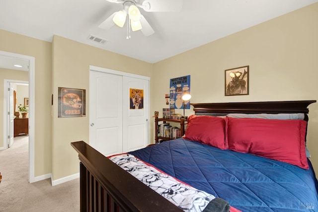 carpeted bedroom featuring a closet, visible vents, ceiling fan, and baseboards