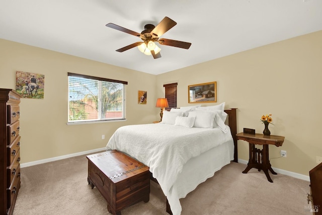 bedroom featuring light carpet, ceiling fan, and baseboards