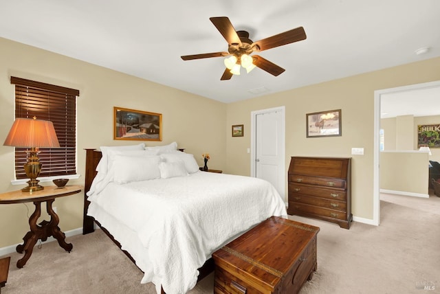 bedroom featuring baseboards, ceiling fan, visible vents, and light colored carpet