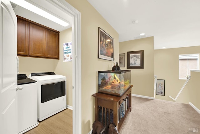 laundry room featuring recessed lighting, light colored carpet, cabinet space, washing machine and dryer, and baseboards